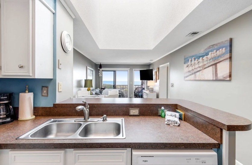 Kitchen looking through the living area to the ocean at Island Beach & Racquet Club B302