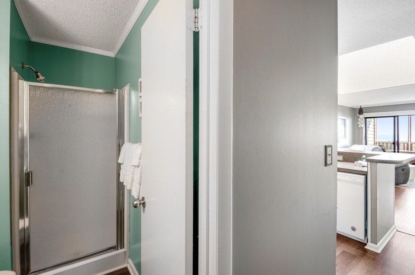 Bathroom with a walk-in shower at Island Beach & Racquet Club B302